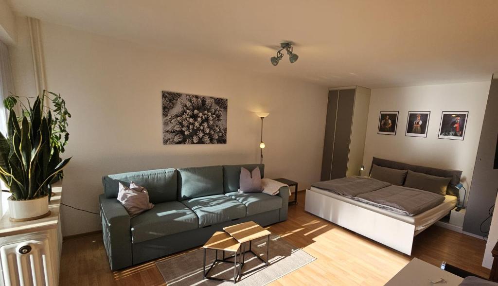 a living room with a couch and a bed at Schanzenblick mit Sauna und Pool in Schonwald im Schwarzwald