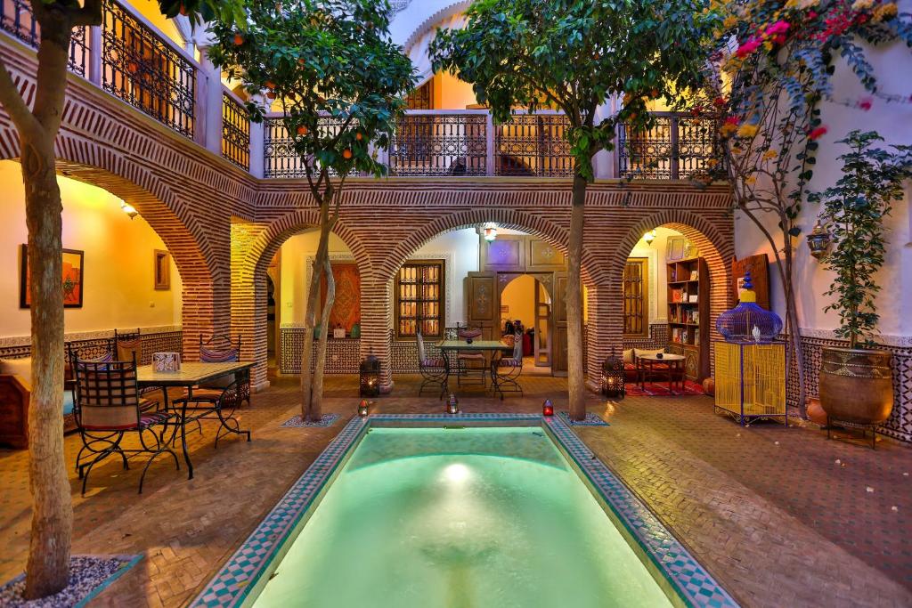 a house with a pool in the middle of a building at Riad Fleur d'Orient in Marrakesh