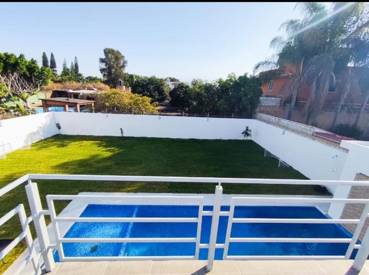 a view of a swimming pool on a white wall at CaSa NeNa in Los Limones