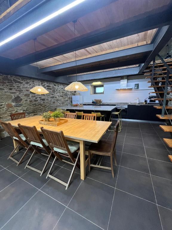 a dining room with a wooden table and chairs at Casa do Páteo in Macieira de Alcoba