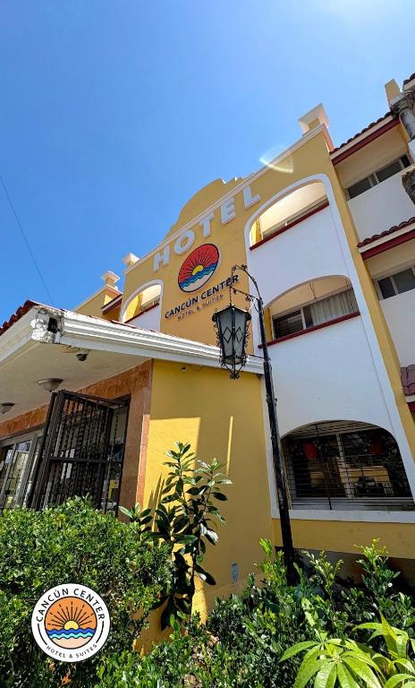 a building with a sign on the side of it at Suites Cancun Center in Cancún