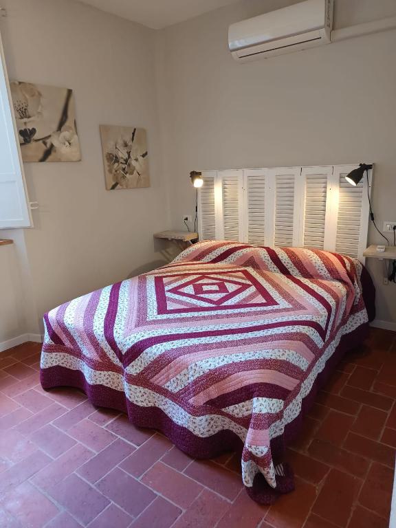 Postel nebo postele na pokoji v ubytování L'Acero Rosso