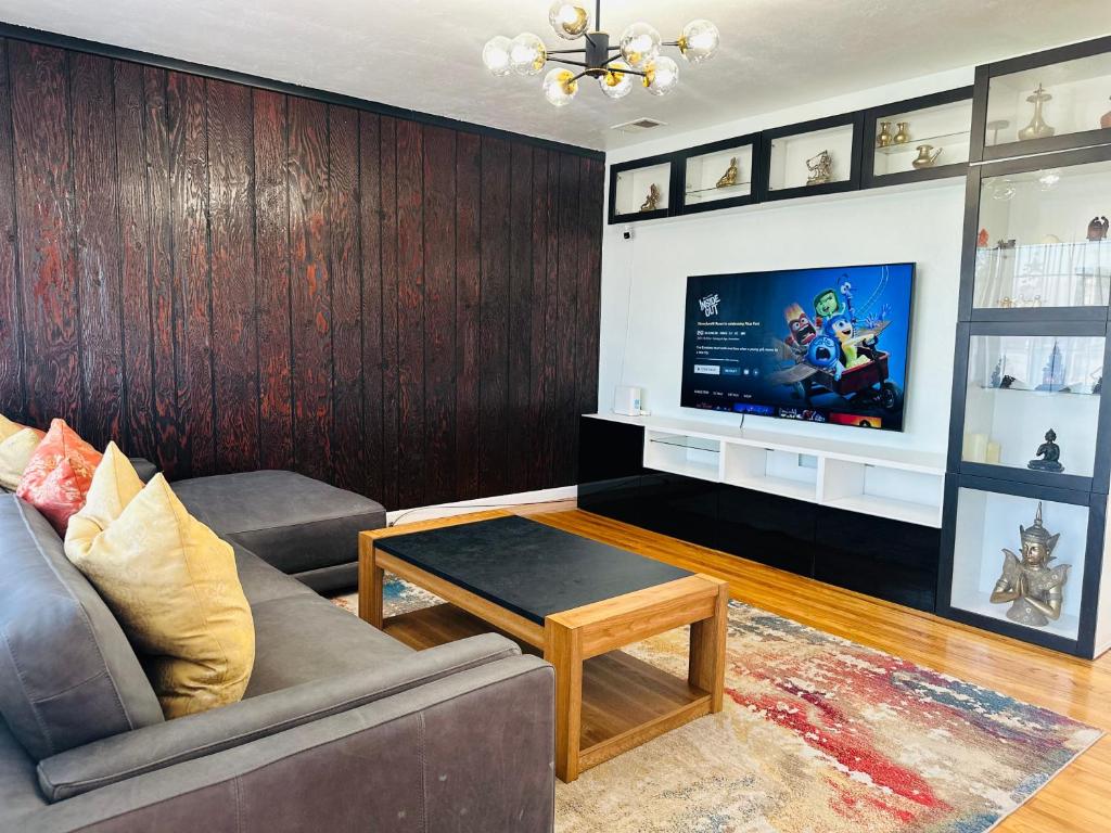 a living room with a couch and a tv at Hayward Home in Hayward