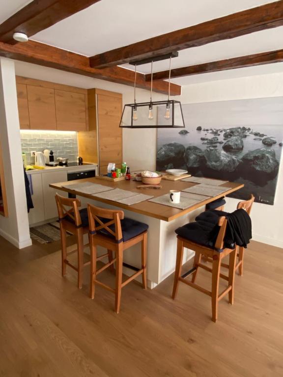 a kitchen with a large wooden table and chairs at Les Boucanier in Verbier