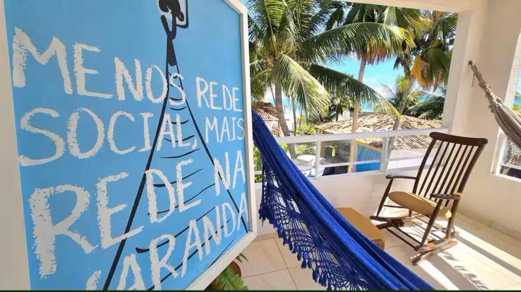 a sign on the front porch of a beach house at Home Beach in Maragogi