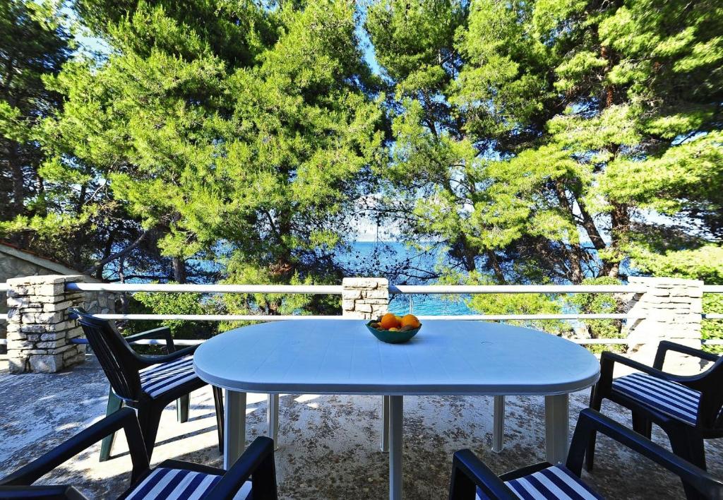 a bowl of fruit sitting on a table on a patio at House Villa Marijeta in Stomorska