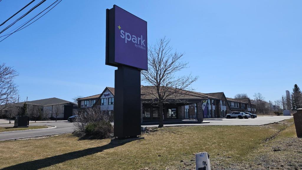 a sign for a spartan gas station on a street at Spark by Hilton Oshawa in Oshawa