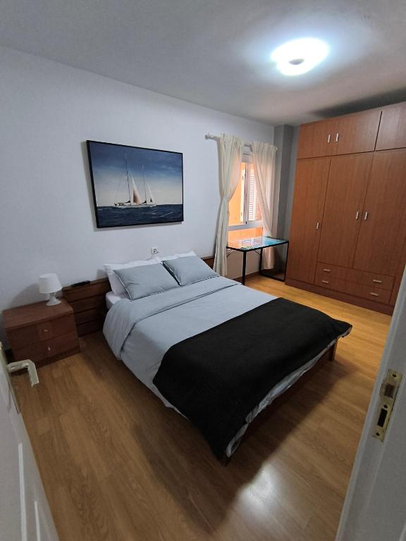 a bedroom with a large bed and a tv on the wall at BRISAS DEL MAR Eddy,,AIR,WIFI in Candelaria