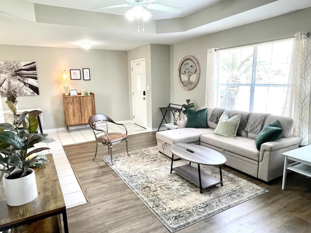 a living room with a couch and a table at Peaceful Haven 2BR 1BA in Quiet Neighborhood in Nederland