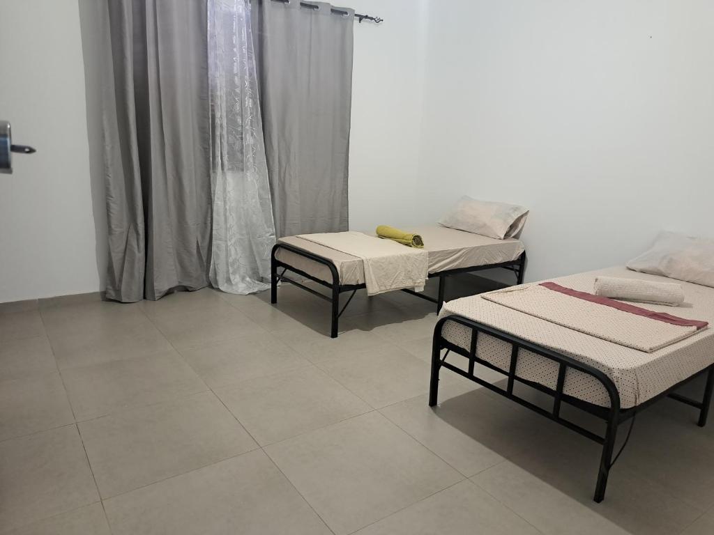 Postel nebo postele na pokoji v ubytování Barros Homestay