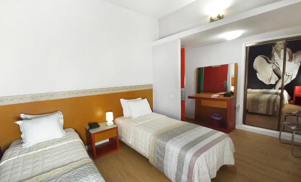 Postel nebo postele na pokoji v ubytování Hotel Joao XXI
