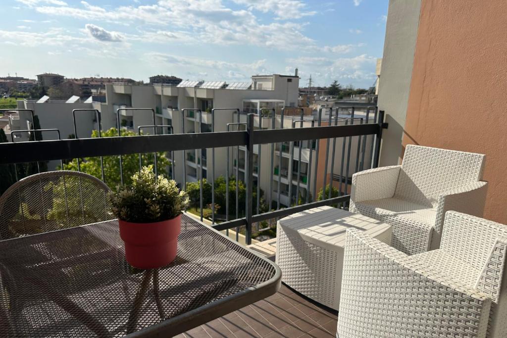 a balcony with two chairs and a table with a plant at TatyHouse in Rome