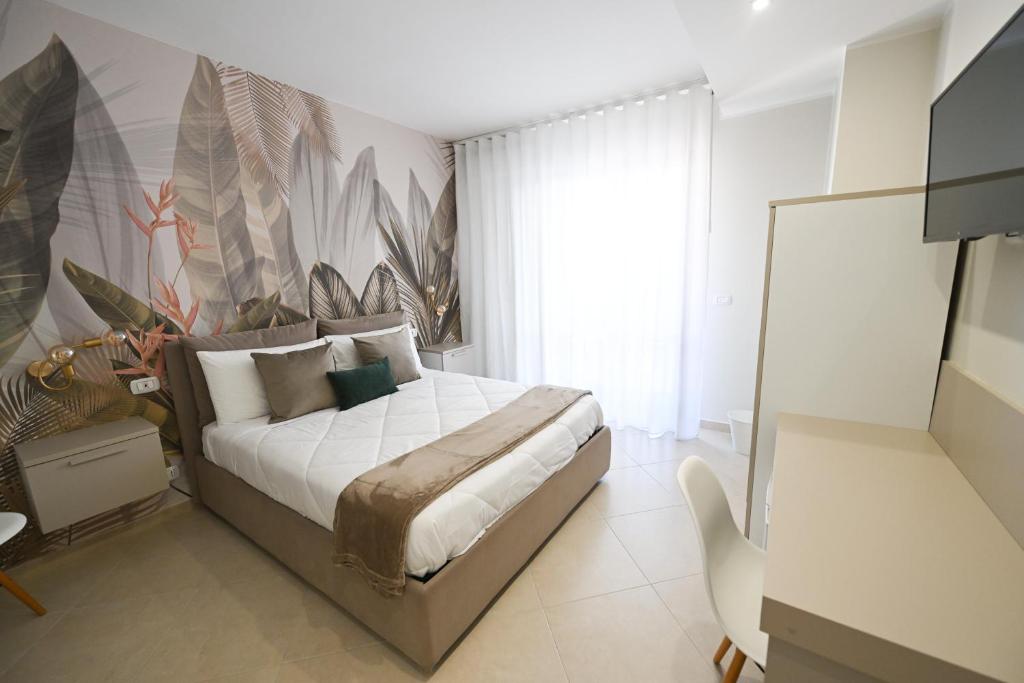 a bedroom with a large bed with a painting on the wall at Barimare in Bari