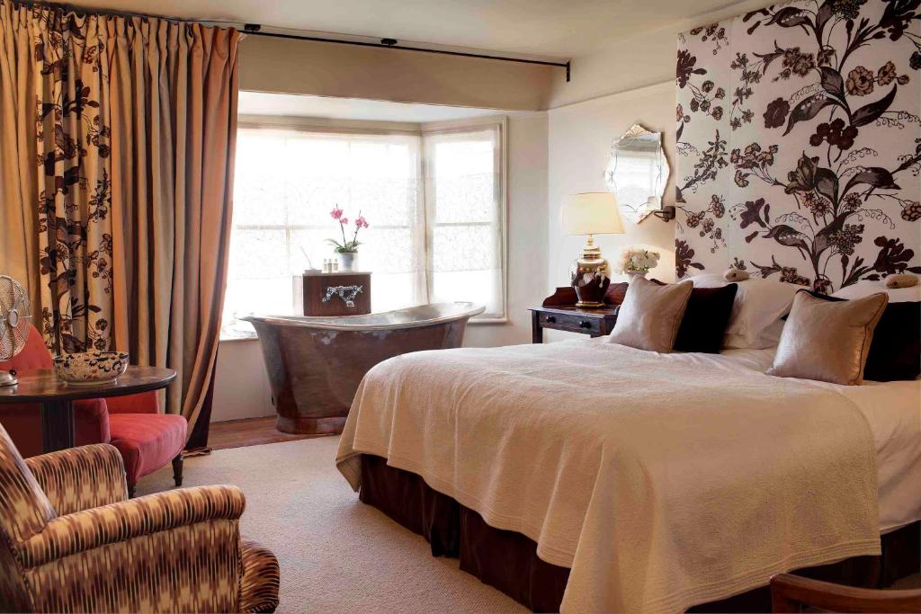 a bedroom with a bed and a chair and a window at The George In Rye in Rye