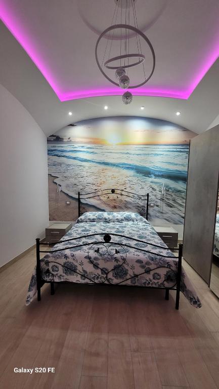 a bedroom with a bed in a room with a painting at Ammiria in Cetara