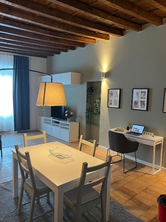 a living room with a table and chairs at Navigli Darsena - Luxury Apartment with balcony in Milan