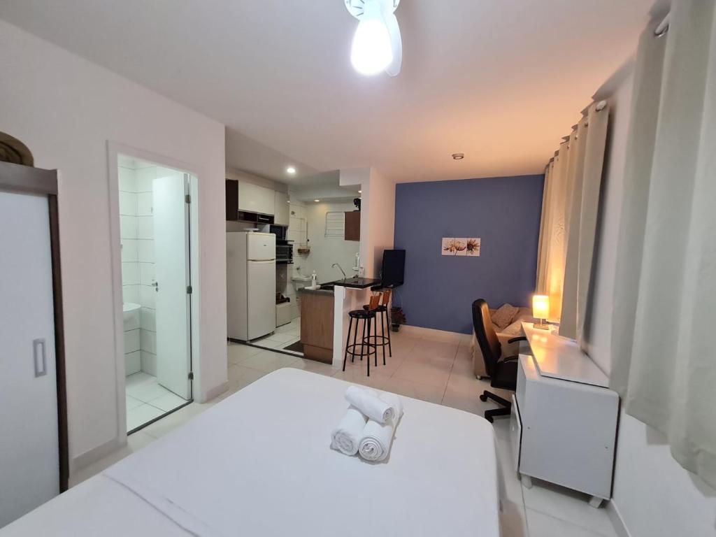 a bedroom with a bed and a living room at Studio próximo Avenida Paulista in Sao Paulo