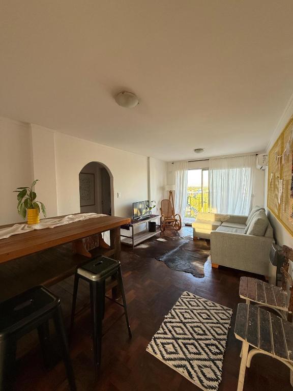 a living room with a table and a couch at Mirador del Puerto in Santa Fe