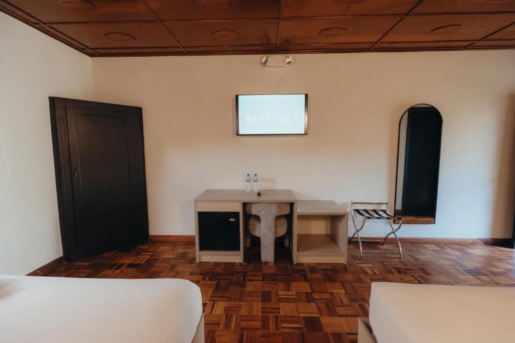 Postel nebo postele na pokoji v ubytování Hotel Boutique Rebequet