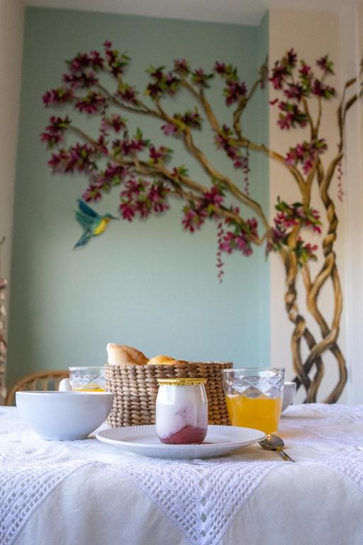 a table with a plate of food and a basket of food at Estúdio AMar - Always Algarve in Porches