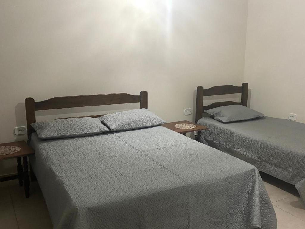 a bedroom with two beds and two night stands at Apartamento Central -Centro Cunha in Cunha