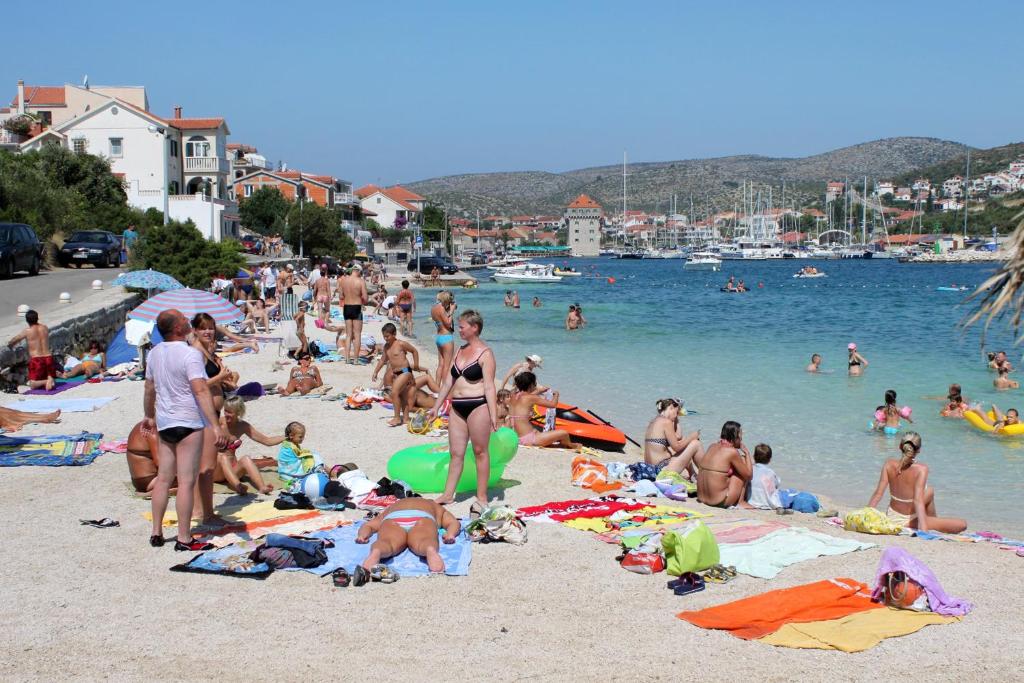 a group of people on a beach in the water at Apartments by the sea Marina, Trogir - 24180 in Marina