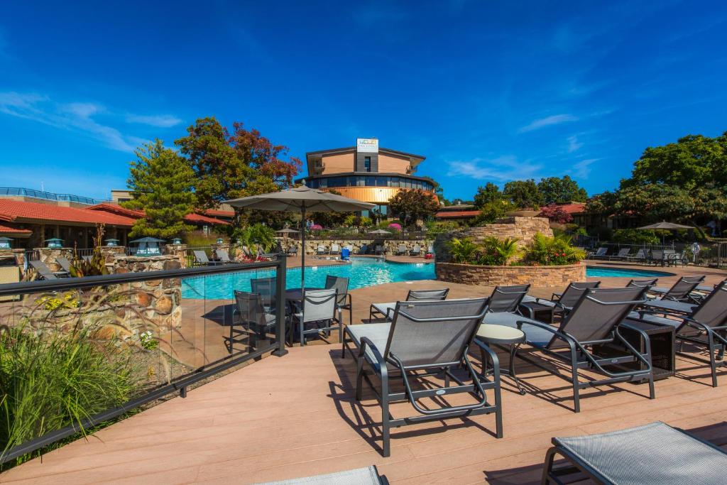 a patio with chairs and a swimming pool at Lodge of Four Seasons Golf Resort, Marina & Spa in Lake Ozark
