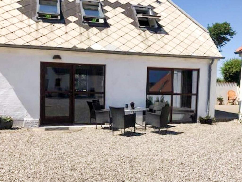 a house with a table and chairs in the yard at 4 star holiday home in Hornsyld in Hornsyld