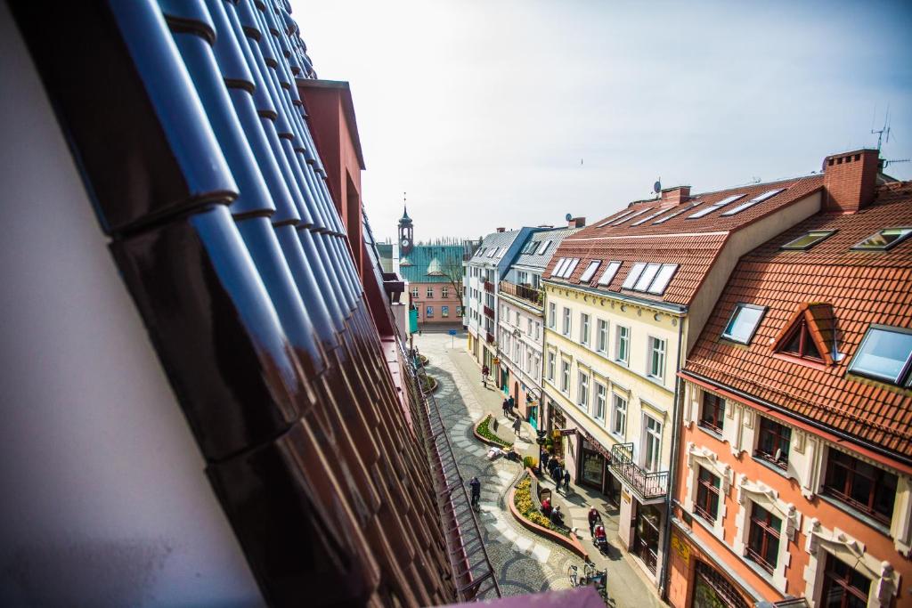 Bird's-eye angle showing tiled roofs and winding pedestrian street with decorative pavement.