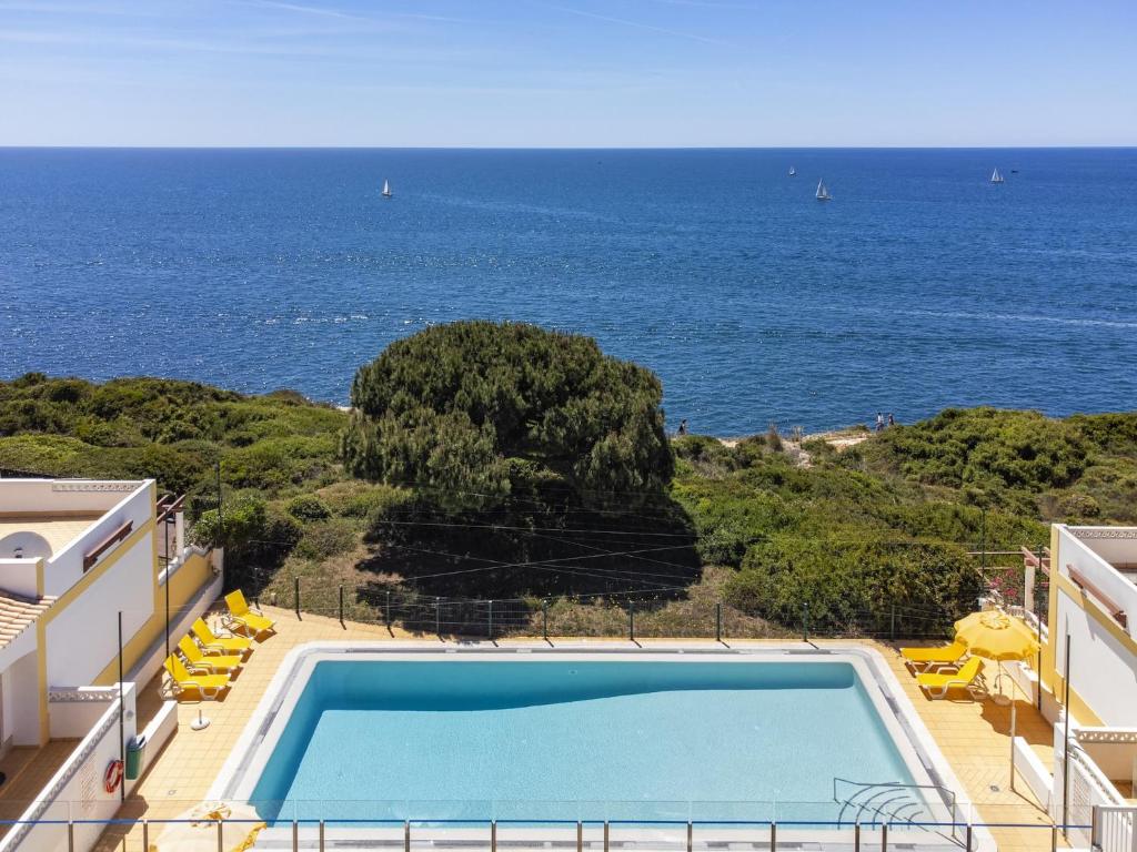 a swimming pool with a view of the ocean at Holiday home near Praia de Benagil beach in Benagil