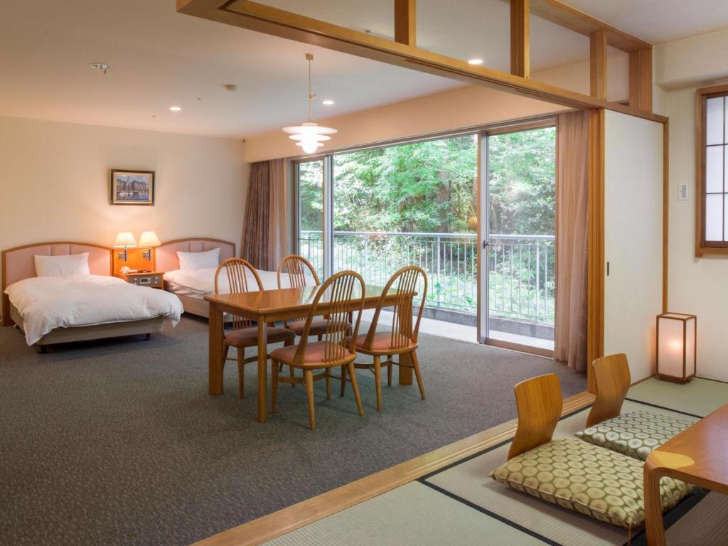 Postel nebo postele na pokoji v ubytování Izumigo AMBIENT Izu-Kogen Condominium