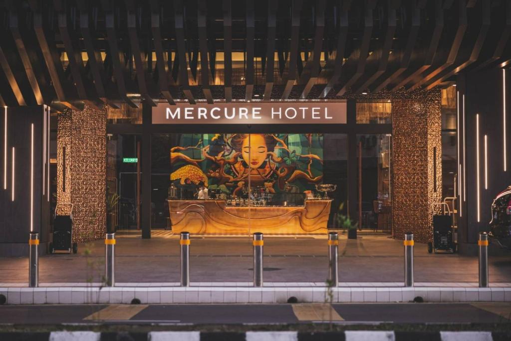 a facade of a mercure hotel with a sign on it at Mercure Miri City Centre in Miri