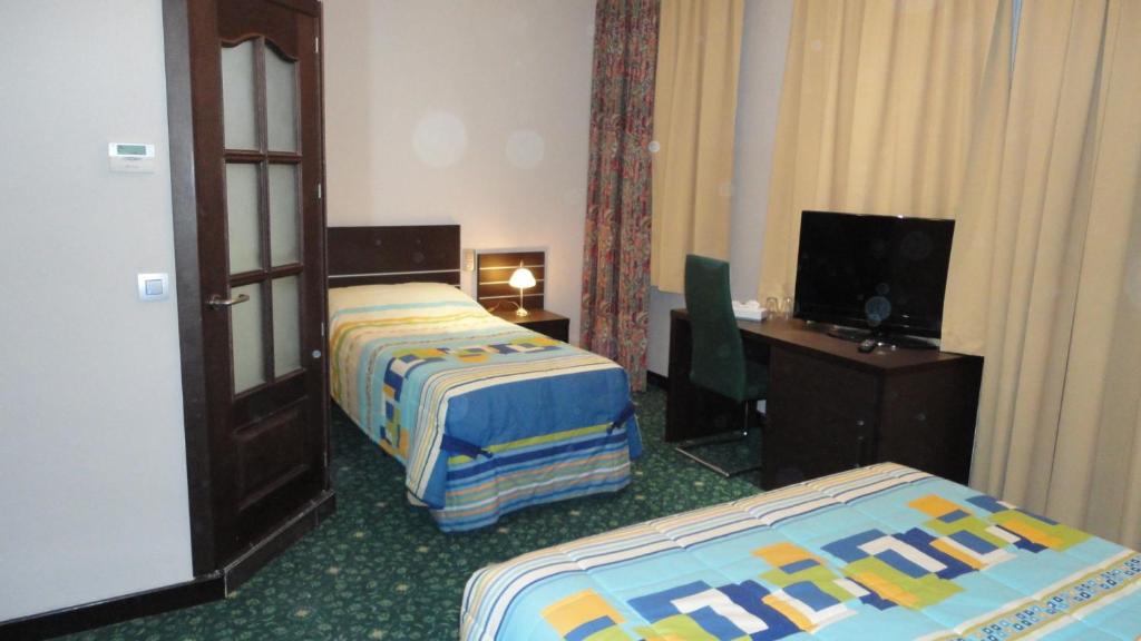 Postel nebo postele na pokoji v ubytování Hotel L'auberge Du Souverain