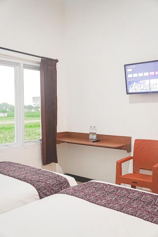 TV a/nebo společenská místnost v ubytování RR -2 Syariah Hotel SLG