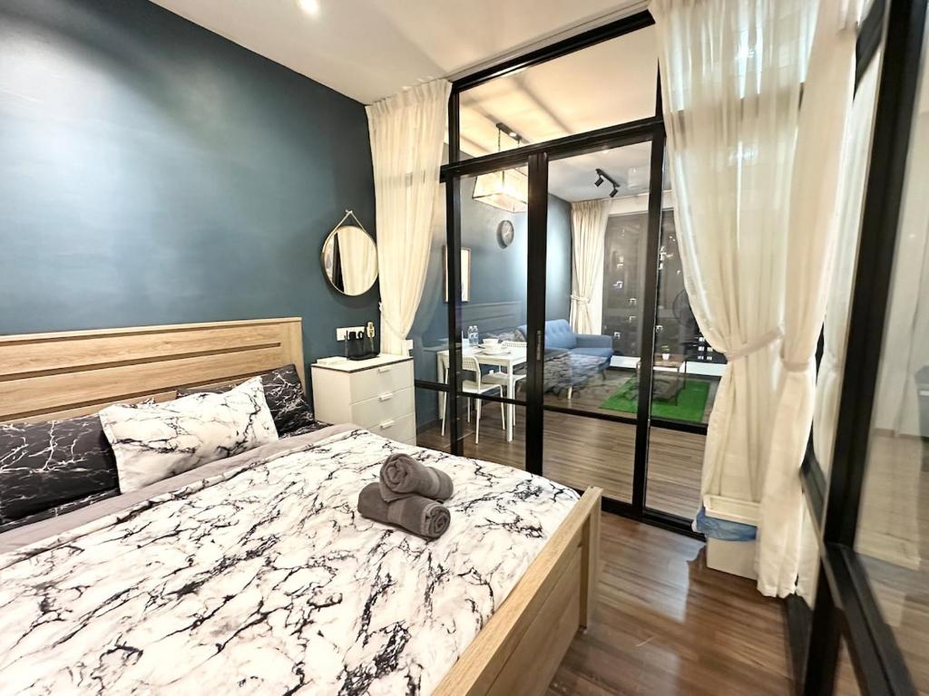 a bedroom with a bed with a teddy bear on it at Silksky - Modern Design, Awesome City View, Free Parking, Free Netflix account, 200mbps WIFI, Privacy, in Serdang