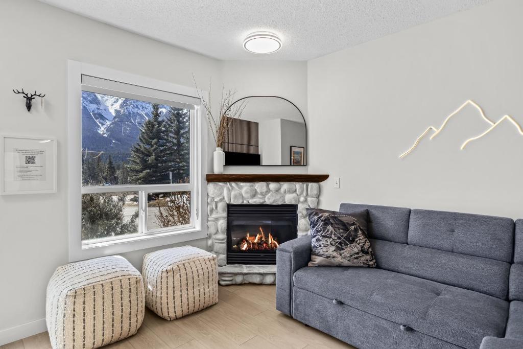a living room with a couch and a fireplace at 2BR 2BA Harvie Heights Townhouse retreat with views in Canmore