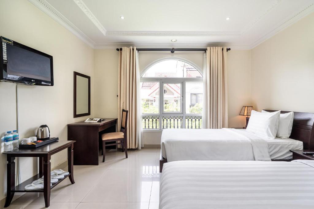 Giường trong phòng chung tại La Bonita Boutique Hotel