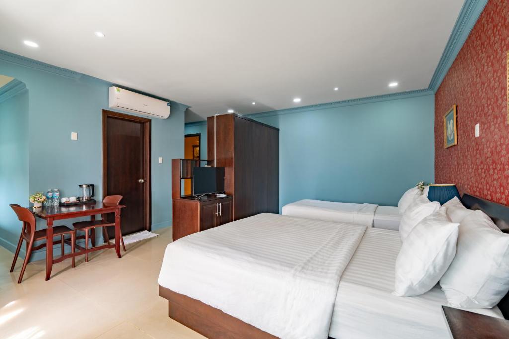 Giường trong phòng chung tại La Bonita Boutique Hotel