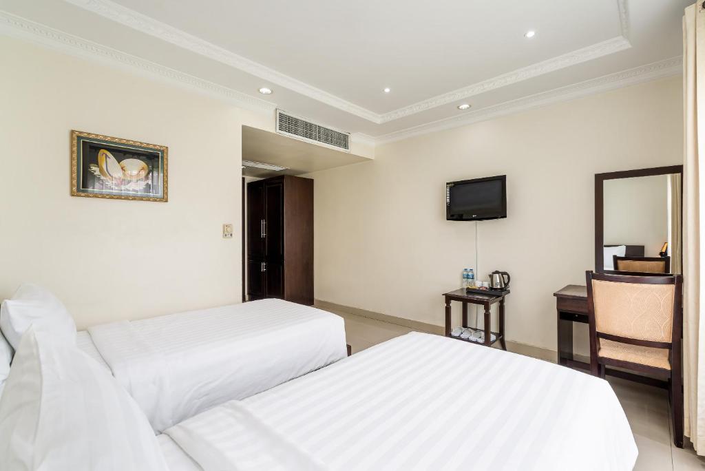 Giường trong phòng chung tại La Bonita Boutique Hotel
