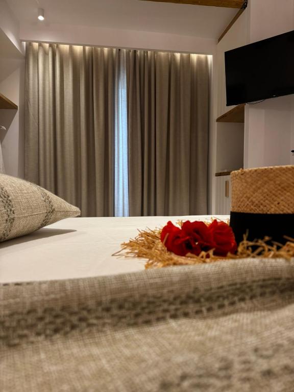 a bedroom with a bed with red roses on it at Naias View Home Milos in Adamantas