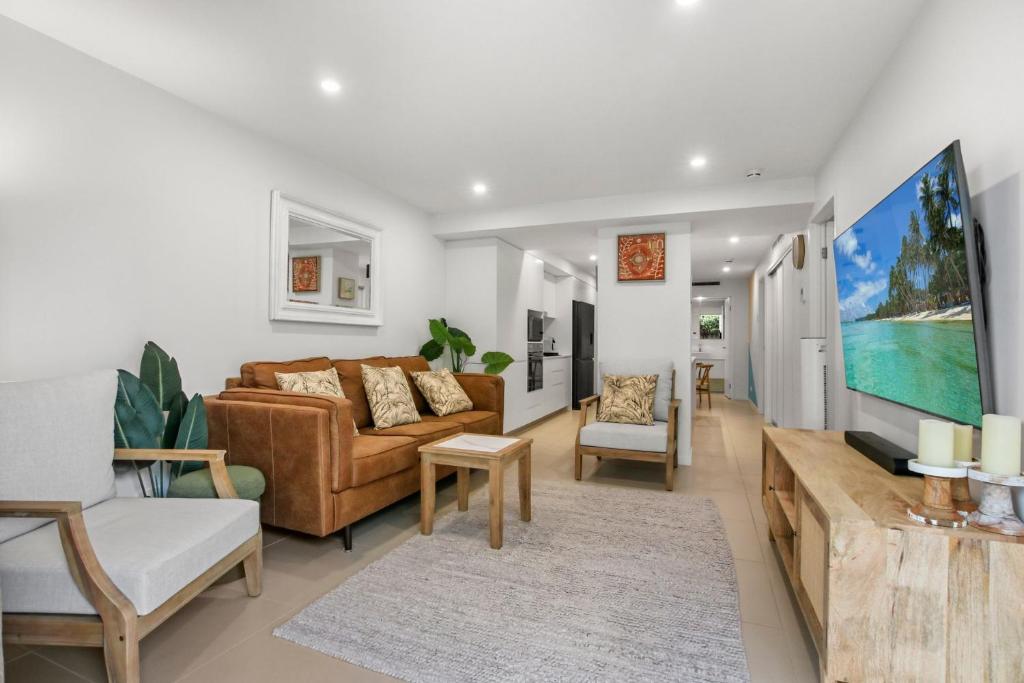 a living room with a couch and a table at Aquaview Unit 103, 29 Canberra Tce, Kings Beach in Caloundra