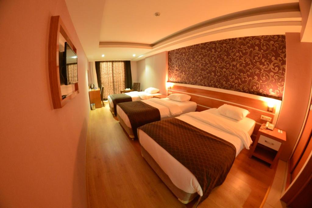 A bed or beds in a room at Bayazıt Hotel