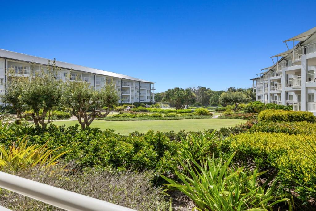 a view of the courtyard of a apartment building at Garden View Apartment in Mantra Salt Beach Resort by uHoliday - 2BR, 1BR and Hotel Room configurations available in Kingscliff