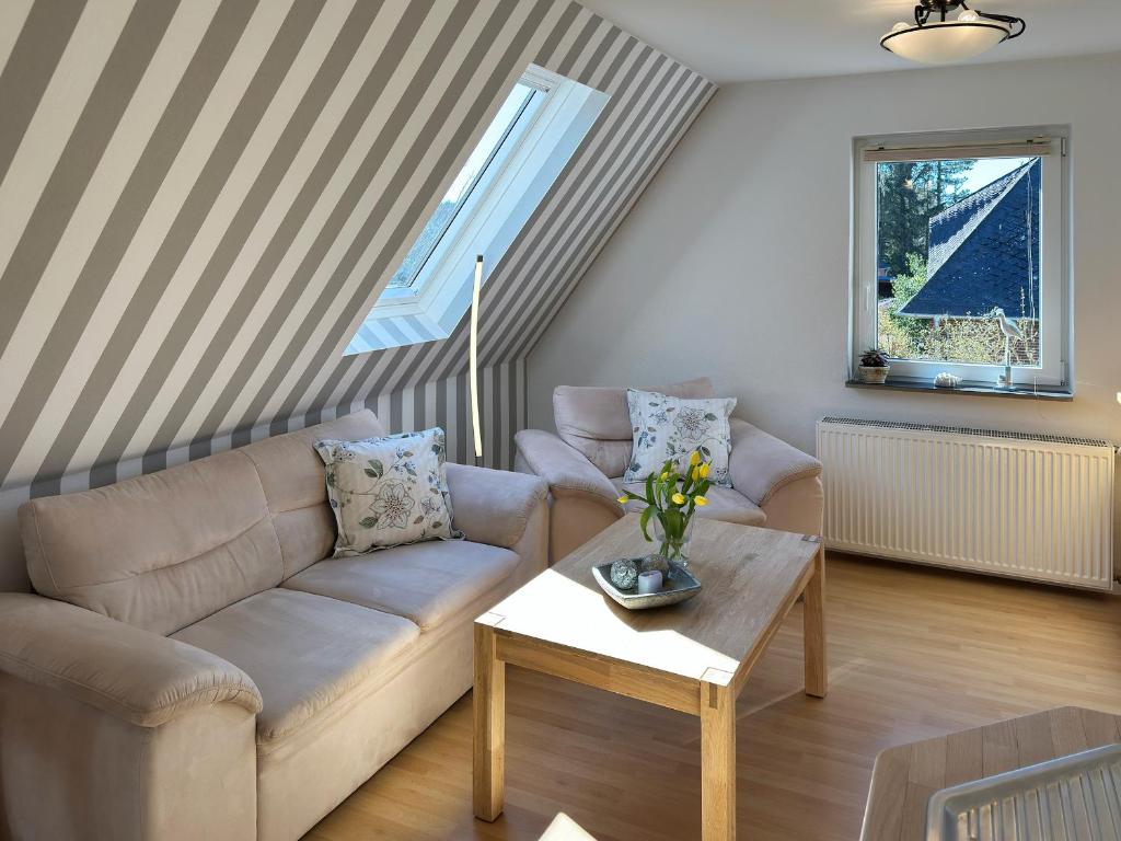 a living room with a couch and a table at Ferienwohnung *Hüs Pelle* in Süddorf