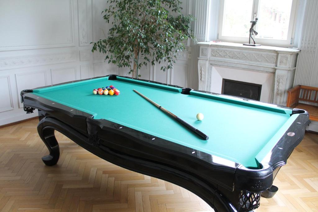 a pool table with balls on it in a room at Villa Élyane in Colmar