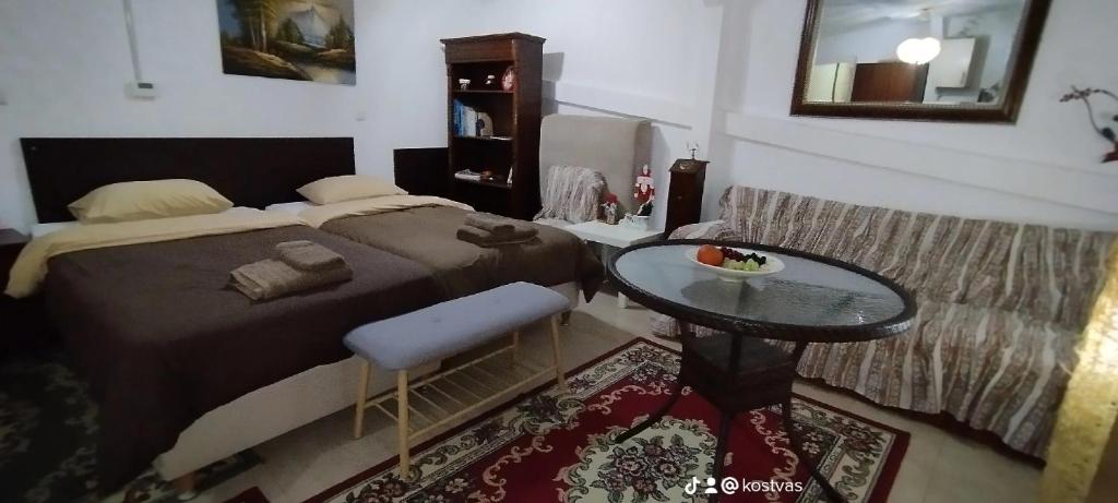 a bedroom with a bed and a glass table at Trikala Apartments 3 in Tríkala