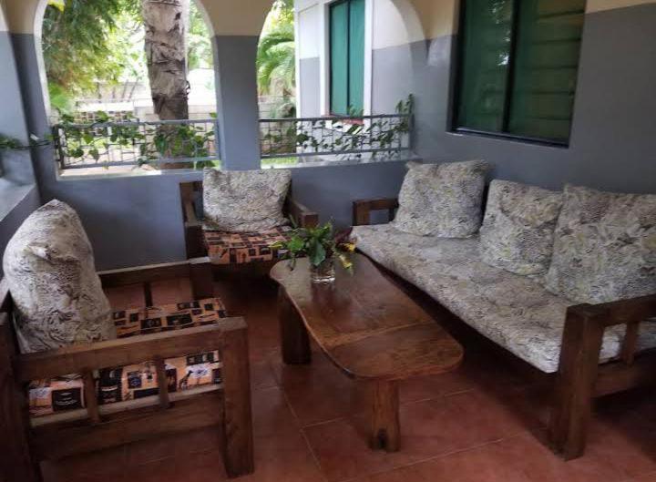 una sala de estar con un sofá y una mesa en Gold villa2, en Diani Beach