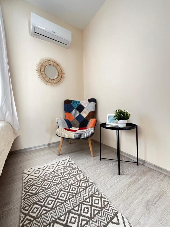 a living room with a chair and a table at Luxury Lotus REZİDANCE 2oda1salon in Kyrenia