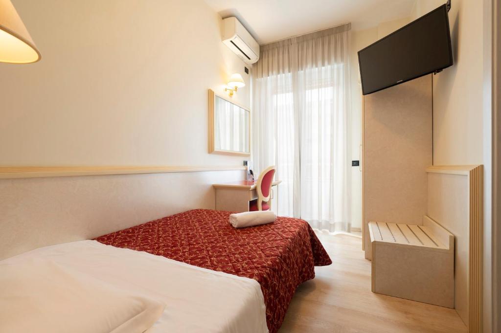 Кровать или кровати в номере Hotel Mondial
