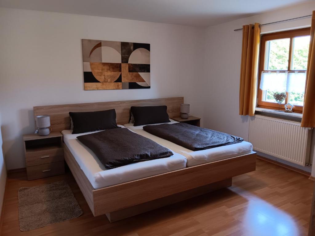 a bedroom with a large bed and a window at Ferienwohnung Butterfly in Lam